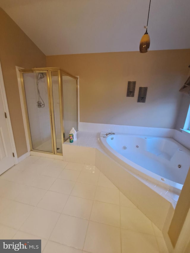 bathroom featuring tile patterned flooring, independent shower and bath, and vaulted ceiling