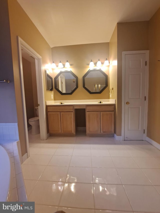 bathroom featuring a tub to relax in, tile patterned flooring, vanity, and toilet