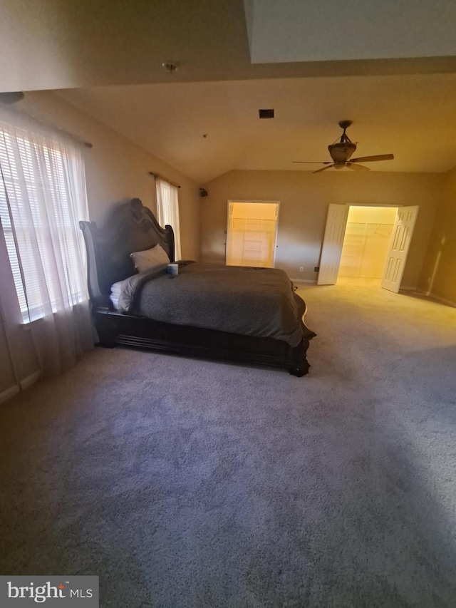 carpeted bedroom featuring vaulted ceiling and ceiling fan