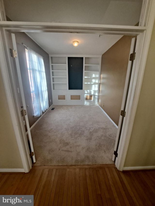 hall with hardwood / wood-style flooring