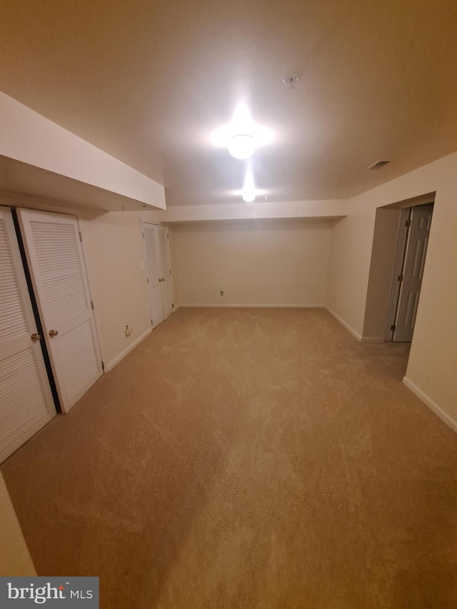 basement featuring light colored carpet