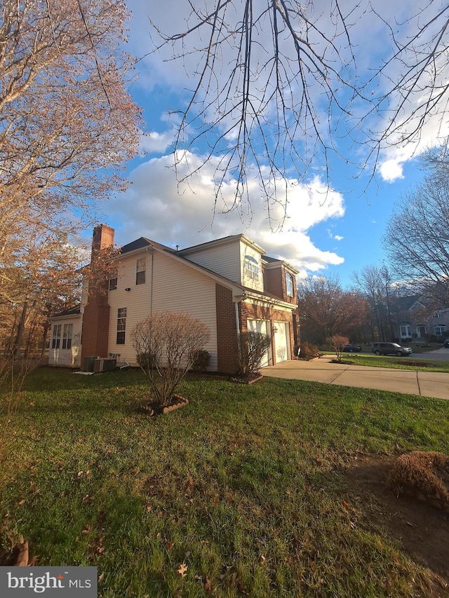 view of property exterior featuring a garage and a lawn