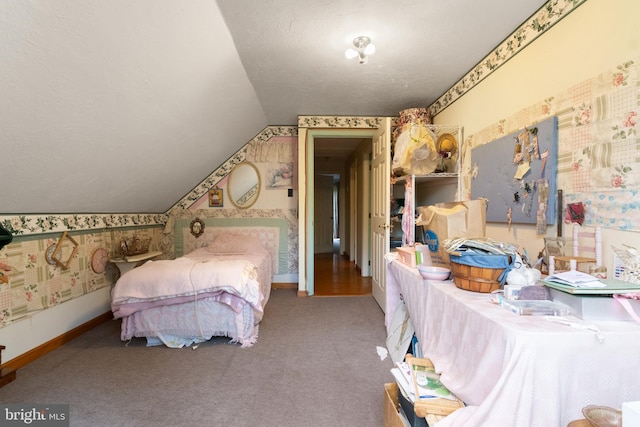 carpeted bedroom with a textured ceiling and lofted ceiling