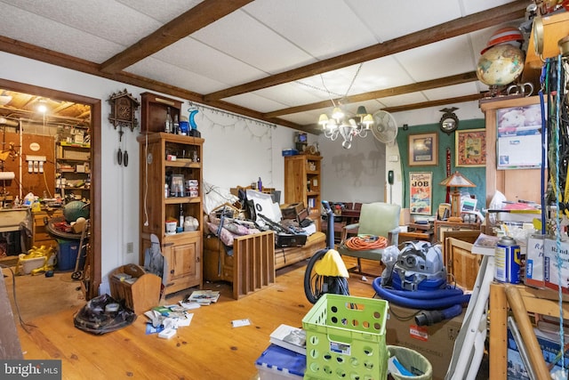 miscellaneous room with hardwood / wood-style floors and an inviting chandelier