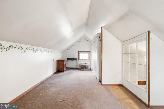 bonus room featuring light colored carpet and vaulted ceiling