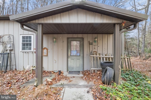 view of exterior entry with a porch