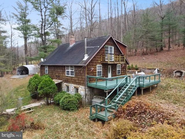 back of property with a wooden deck