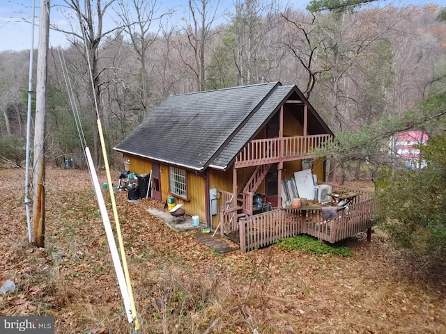 view of property exterior featuring an outdoor hangout area and a wooden deck