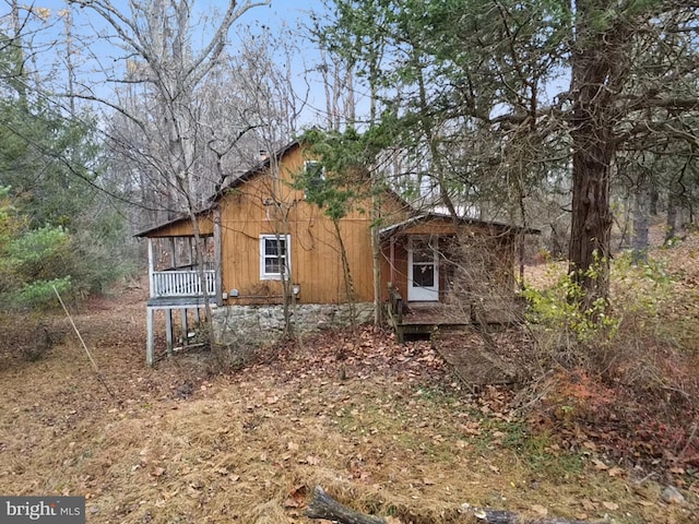 back of property featuring a porch