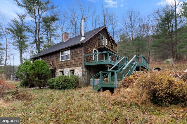 back of house with a wooden deck