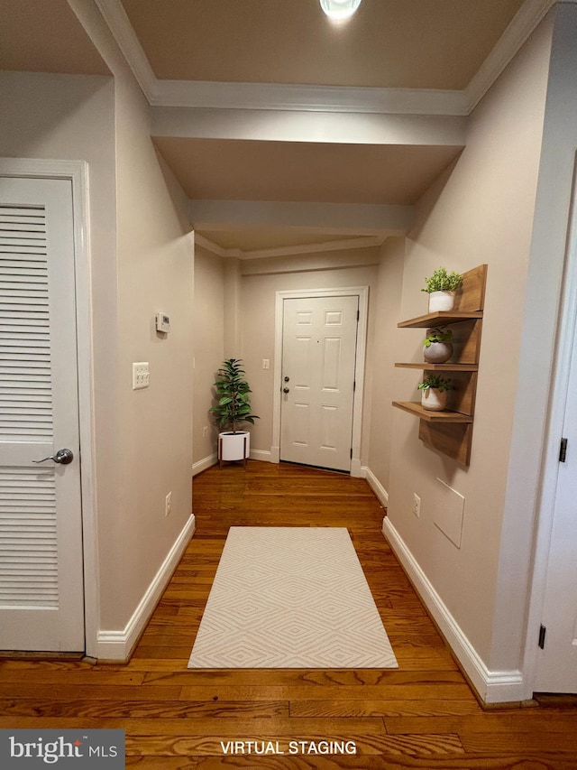 doorway featuring dark hardwood / wood-style floors and crown molding