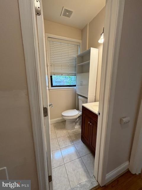 bathroom with vanity, tile patterned floors, and toilet