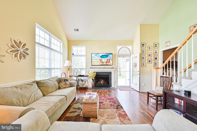 40 Vender Ln, Mays Landing, NJ 08330 - living area featuring high vaulted ceiling, wood finished floors, a warm lit fireplace, wainscoting, and stairs