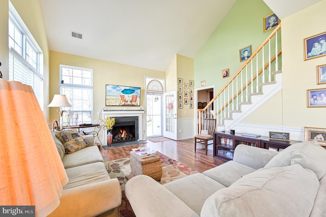 living room featuring hardwood / wood-style floors and high vaulted ceiling