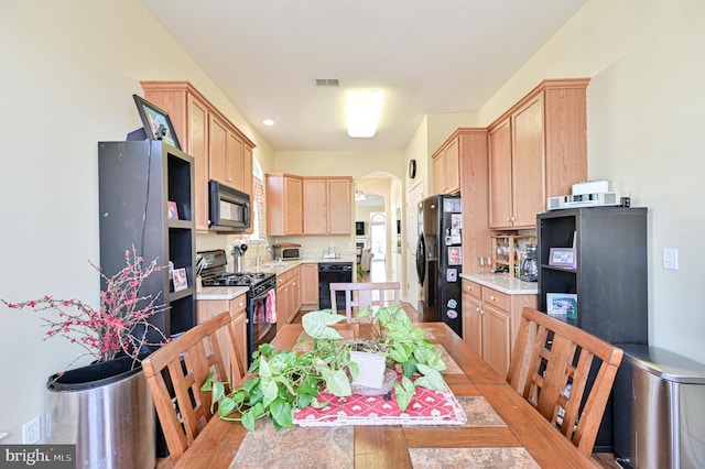 40 Vender Ln, Mays Landing, NJ 08330 - kitchen with black appliances, light brown cabinetry, light countertops, arched walkways, and recessed lighting