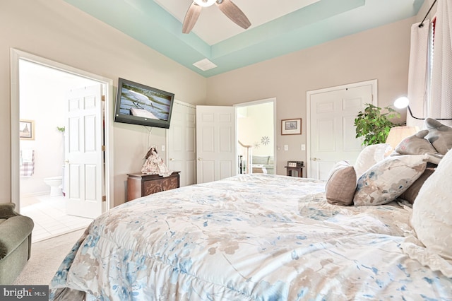 carpeted bedroom featuring ensuite bath and ceiling fan