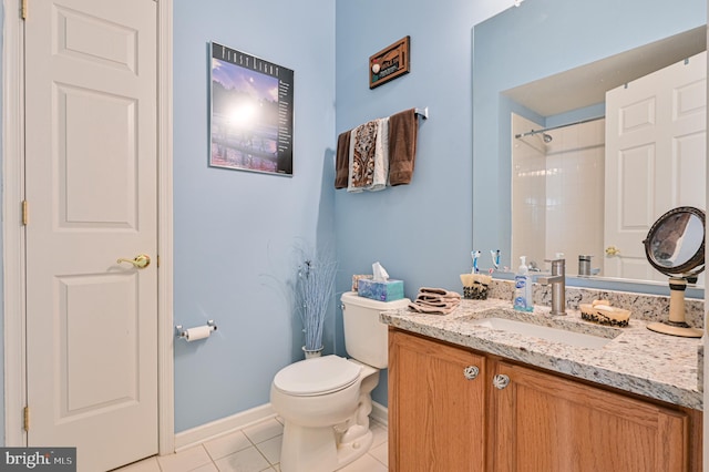 bathroom featuring toilet, vanity, tile patterned flooring, and tiled shower