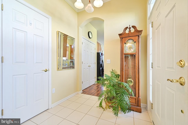 foyer with light tile patterned flooring and a notable chandelier