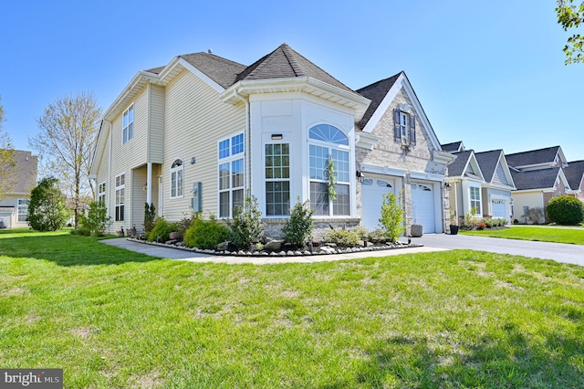 view of front of property featuring a garage and a front lawn