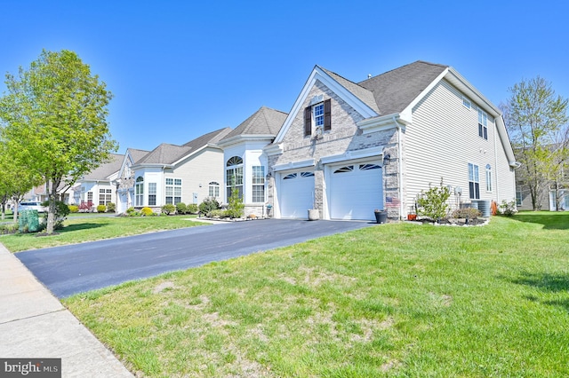 40 Vender Ln, Mays Landing, NJ 08330 - view of front of house with asphalt driveway, stone siding, a front yard, and a garage