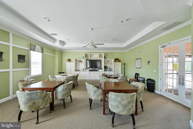 dining space featuring a wealth of natural light, ceiling fan, crown molding, and a tray ceiling