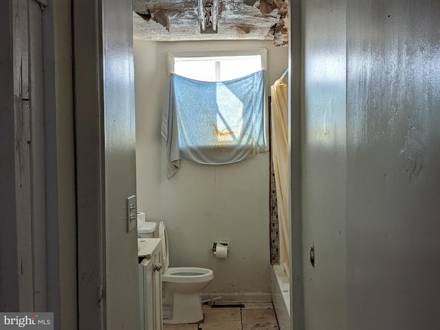 bathroom with tile patterned flooring, vanity, toilet, and curtained shower