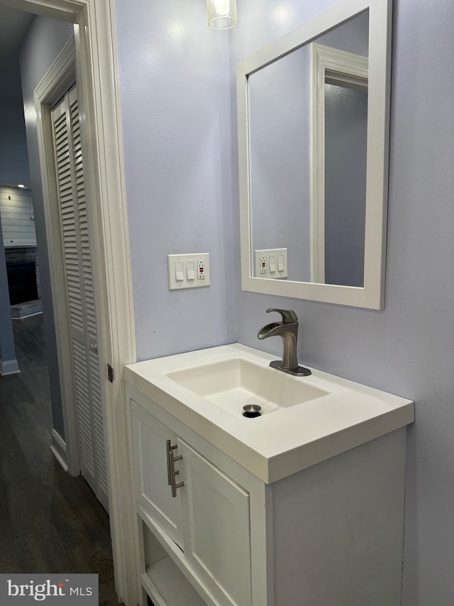 bathroom with hardwood / wood-style floors and vanity