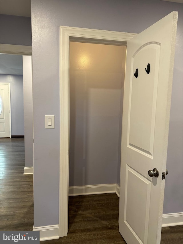 corridor featuring dark hardwood / wood-style floors