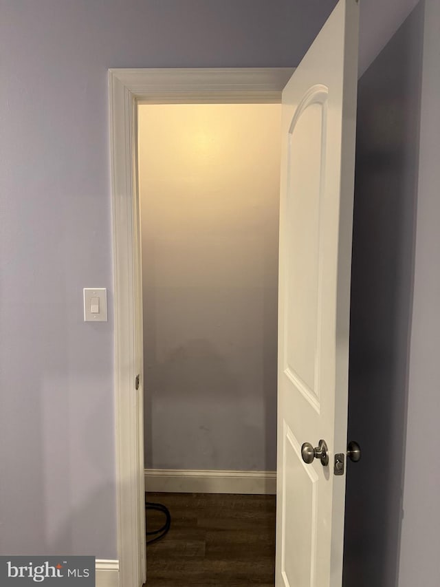 corridor featuring dark hardwood / wood-style floors