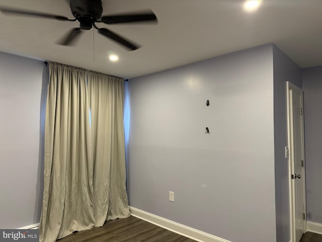 empty room featuring ceiling fan and dark hardwood / wood-style flooring