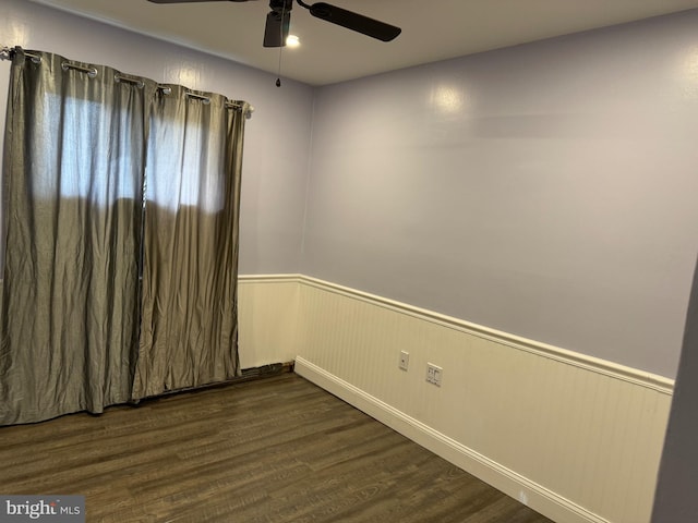 spare room with ceiling fan and dark wood-type flooring