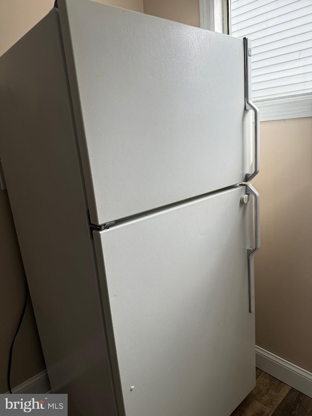 interior details with wood-type flooring and white fridge