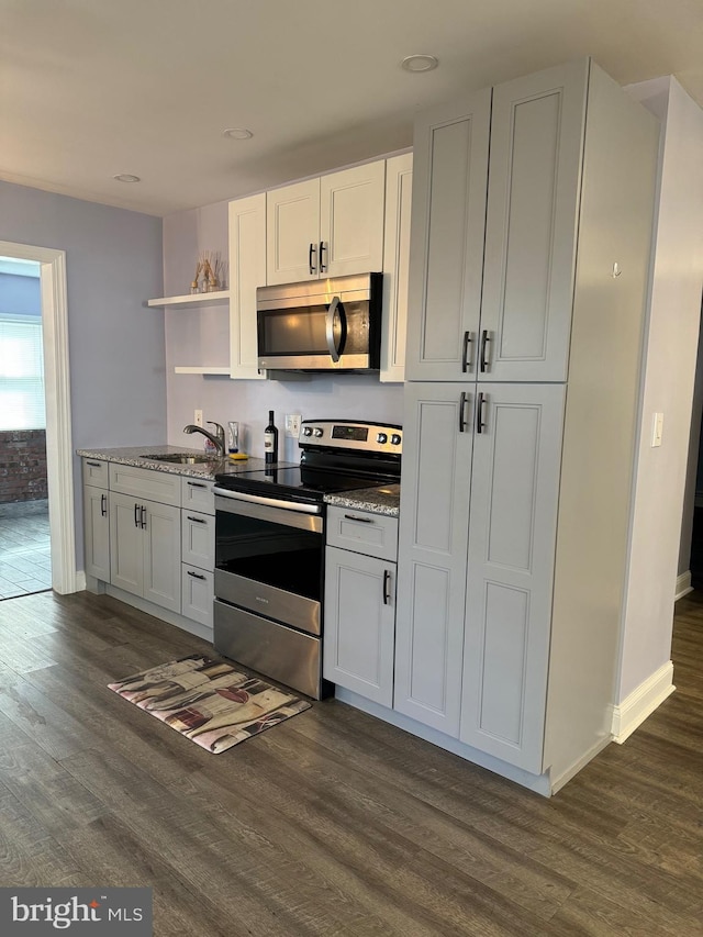 kitchen featuring white cabinets, dark hardwood / wood-style flooring, and stainless steel appliances