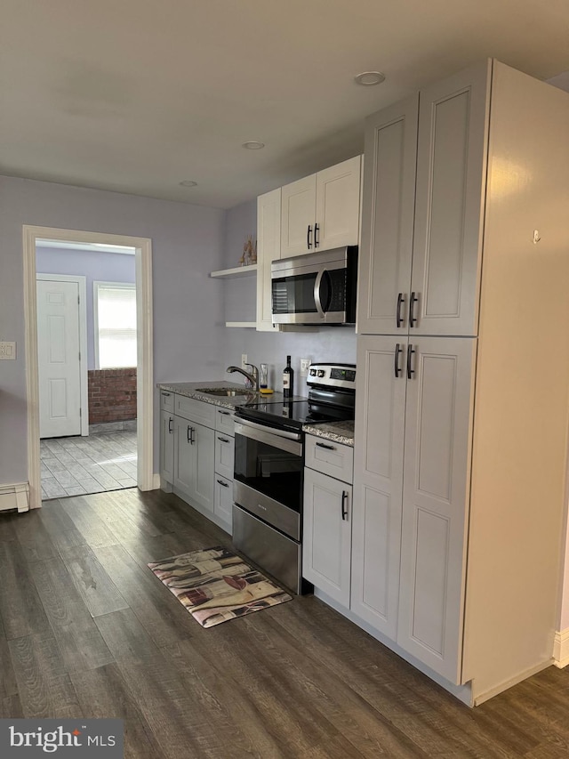 kitchen featuring dark hardwood / wood-style floors, white cabinetry, and stainless steel appliances