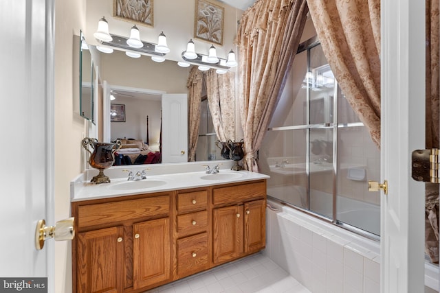 bathroom featuring enclosed tub / shower combo, vanity, and tile patterned flooring