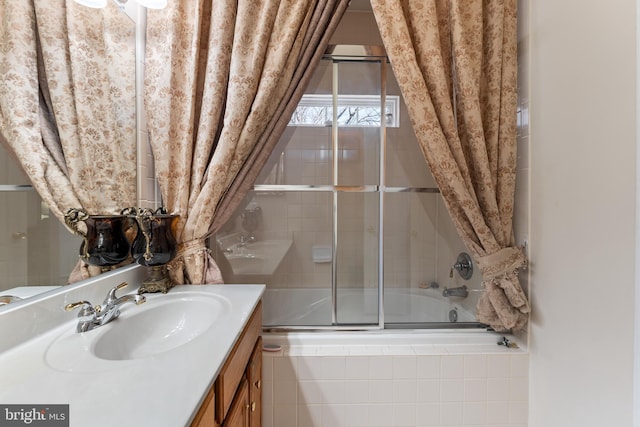 bathroom with enclosed tub / shower combo, lofted ceiling, and vanity