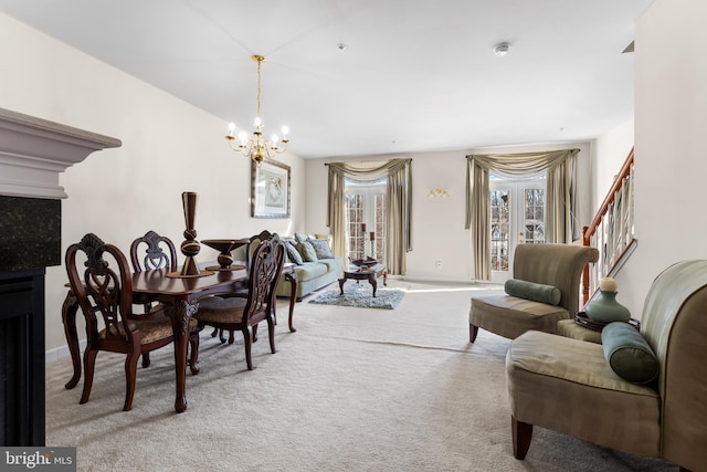 carpeted dining space with an inviting chandelier