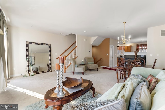 carpeted living room featuring an inviting chandelier and a high end fireplace