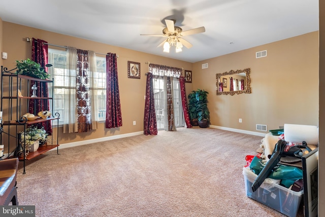 misc room with carpet floors and ceiling fan