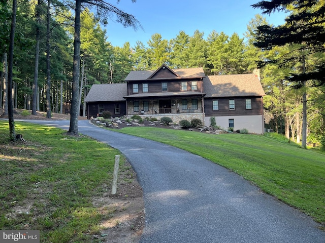 view of front of home featuring a porch and a front lawn