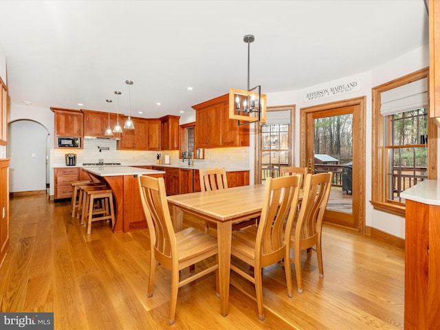 dining area with a chandelier and light hardwood / wood-style flooring