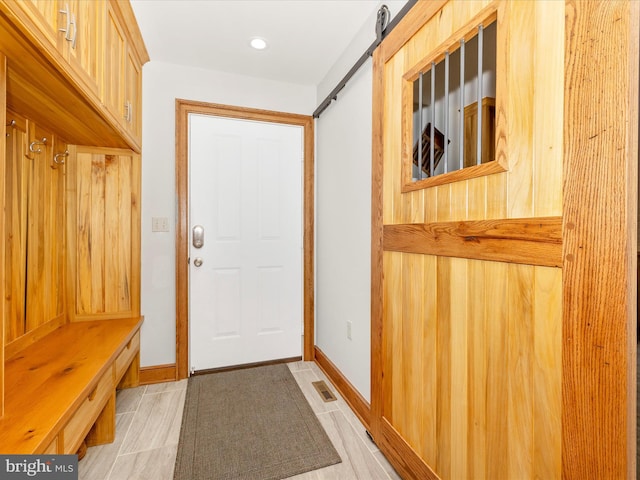 mudroom featuring a barn door