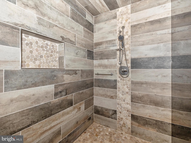 bathroom with a tile shower