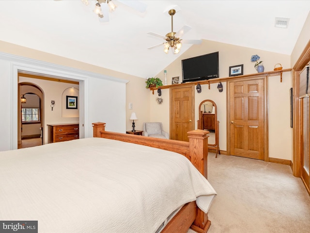 carpeted bedroom with vaulted ceiling and ceiling fan