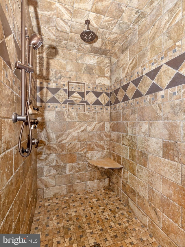 bathroom with tiled shower