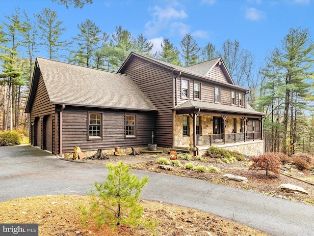 view of front of home with a porch and a garage