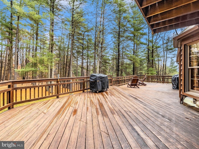 wooden terrace featuring a grill