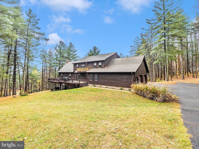 exterior space featuring a lawn and a deck