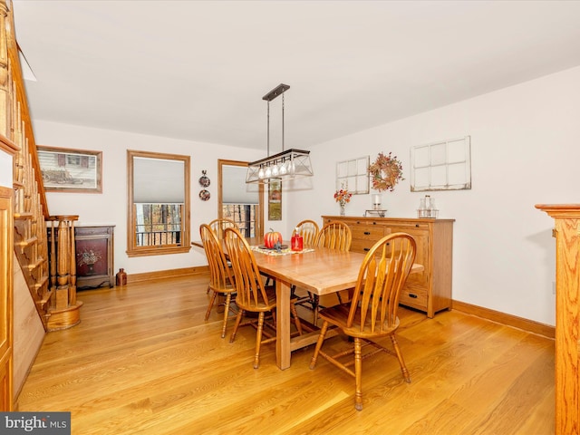 4414 Mountville Rd, Frederick, MD 21703 - dining room featuring light wood-style floors, baseboards, a chandelier, and stairway