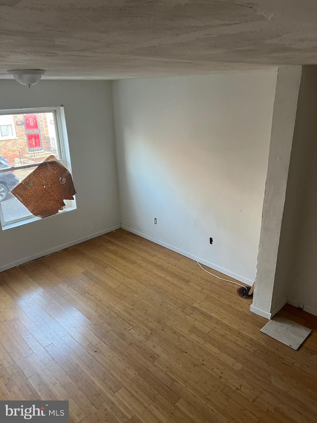 empty room with light hardwood / wood-style flooring